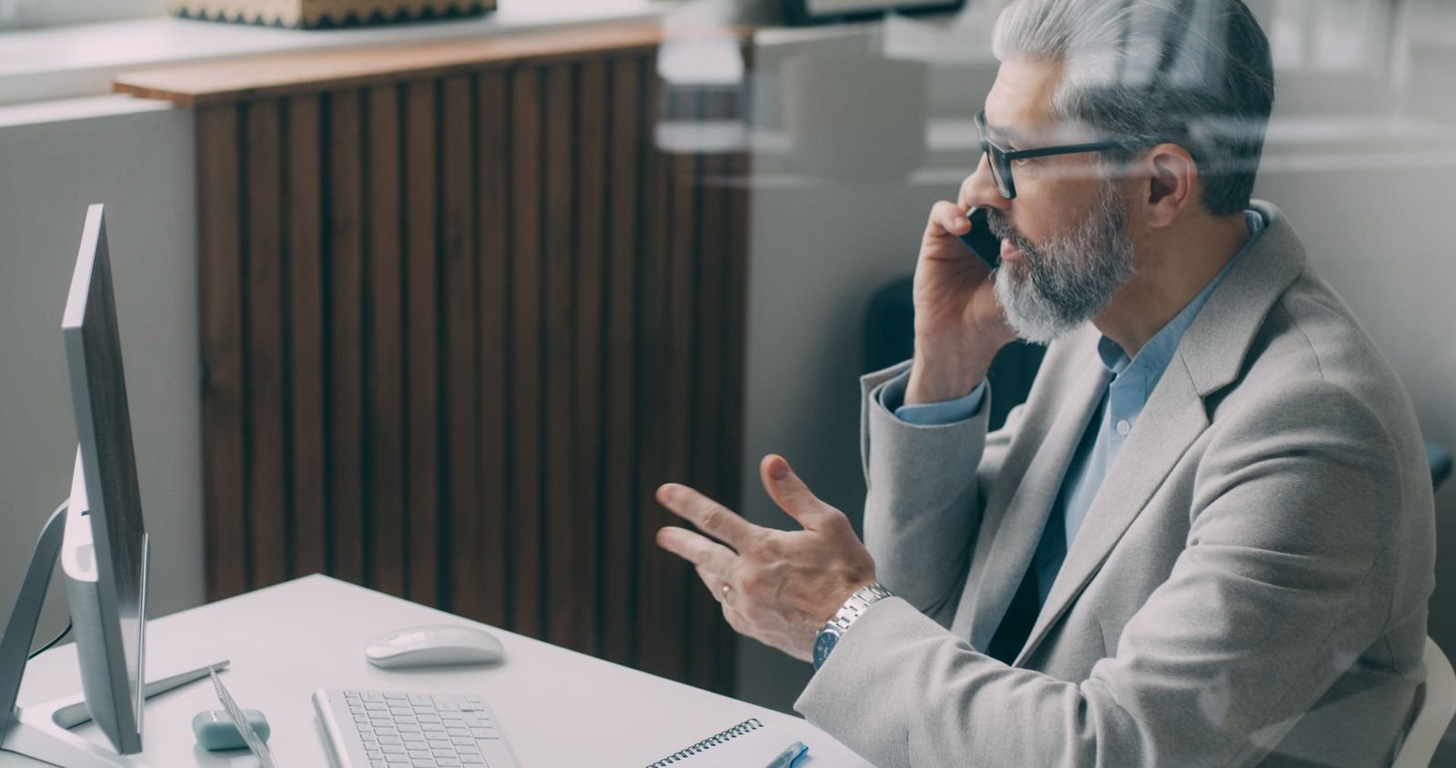 Experienced business consultant speaking with a client from his office
